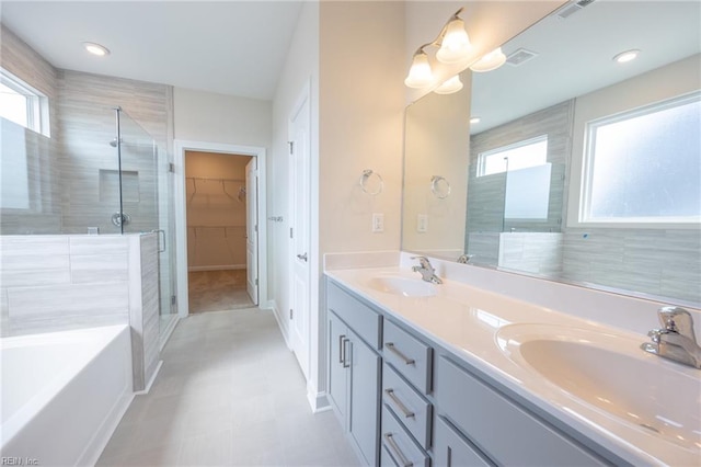 bathroom featuring vanity and shower with separate bathtub