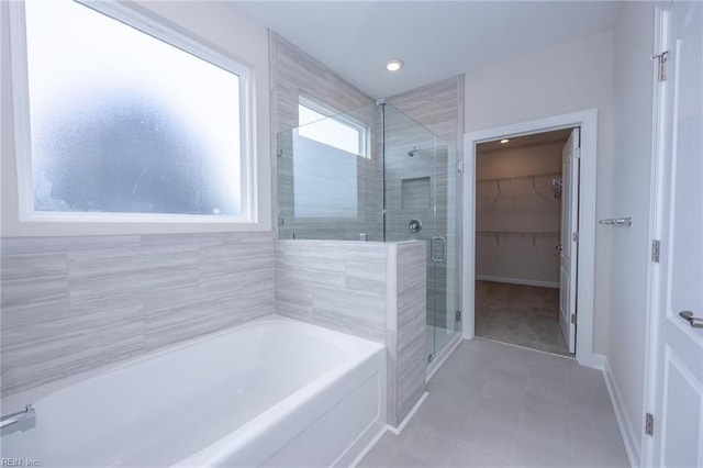 bathroom featuring separate shower and tub