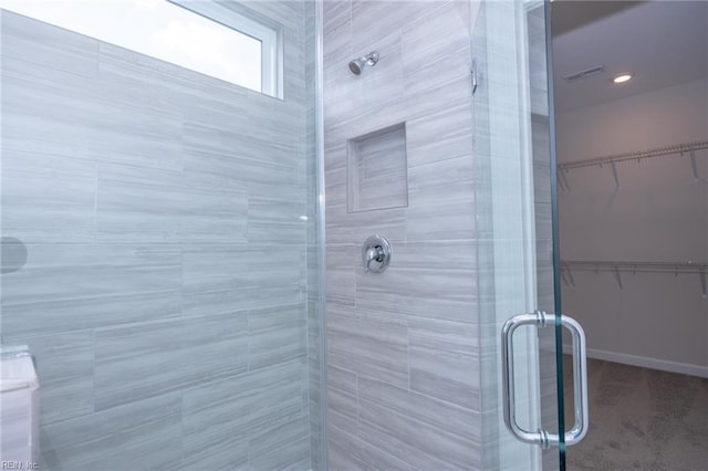 bathroom with a shower with shower door