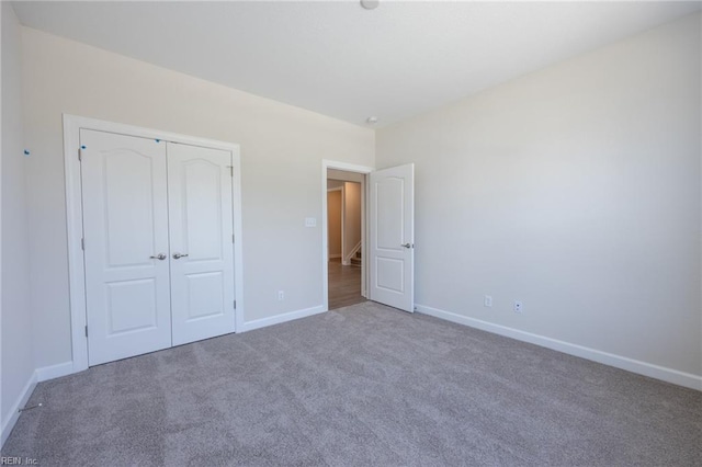 unfurnished bedroom with carpet and a closet