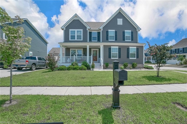 view of front of house featuring a front lawn and covered porch