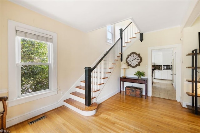 staircase with hardwood / wood-style floors