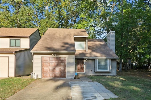 view of front of home with a front yard and a garage