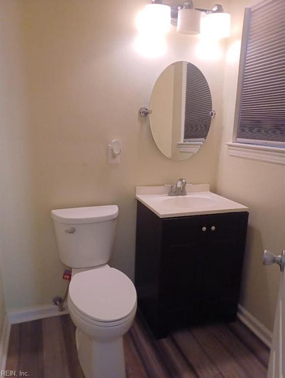 bathroom with vanity, wood-type flooring, and toilet