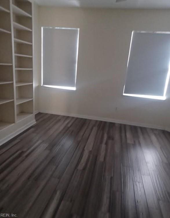 unfurnished room with dark hardwood / wood-style floors