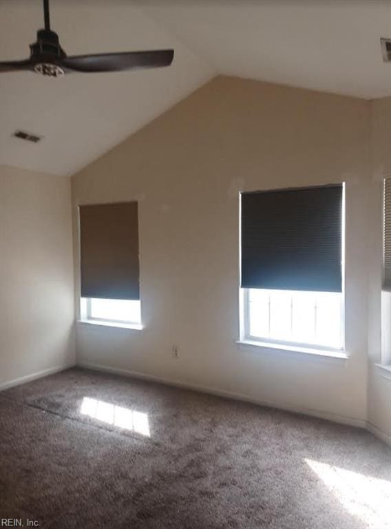 carpeted spare room with lofted ceiling and ceiling fan