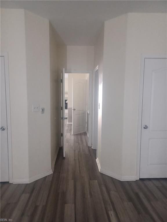 corridor with dark hardwood / wood-style floors