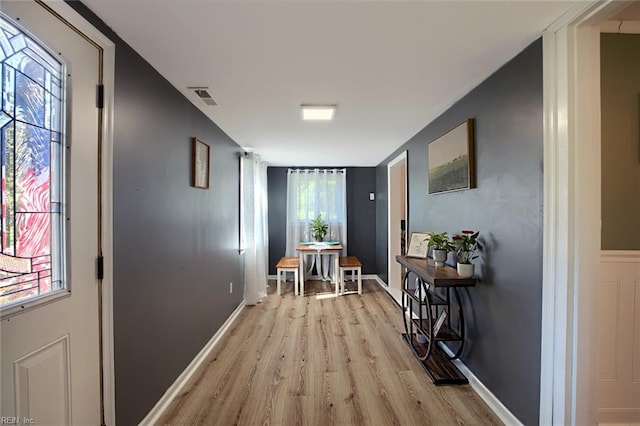 hallway with light hardwood / wood-style flooring