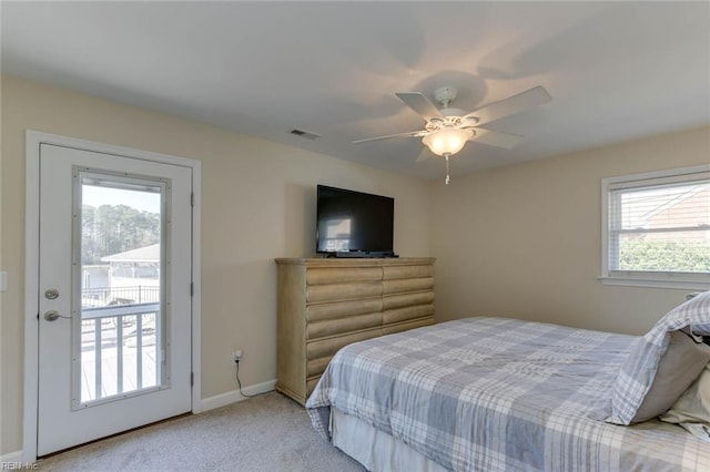 bedroom with light carpet, multiple windows, access to exterior, and ceiling fan