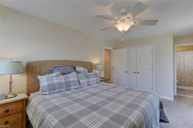 carpeted bedroom with a closet, ensuite bath, and ceiling fan