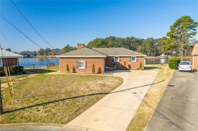 view of front of house featuring a front yard and a water view