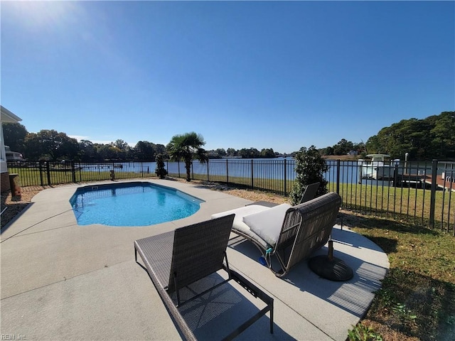 view of swimming pool with a patio area, a yard, and a water view