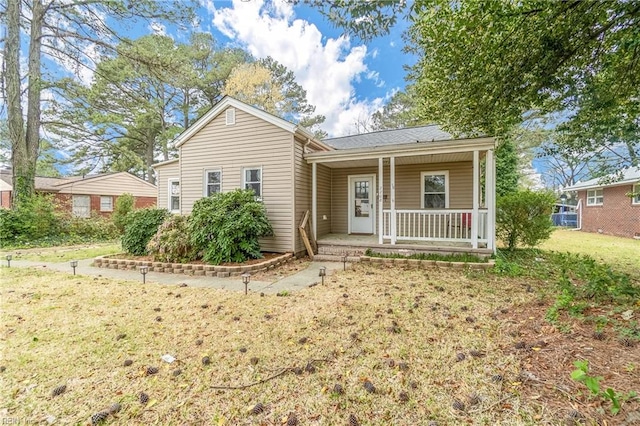 view of front of home featuring covered porch and a front yard