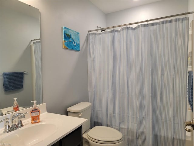 full bathroom featuring vanity, shower / bath combo, and toilet