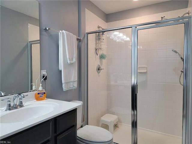 bathroom featuring vanity, toilet, and walk in shower