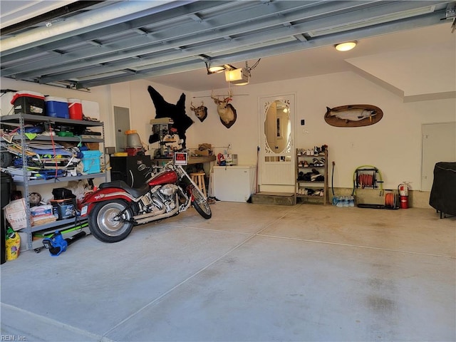 garage with a garage door opener and electric panel