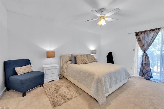 carpeted bedroom featuring access to exterior and ceiling fan