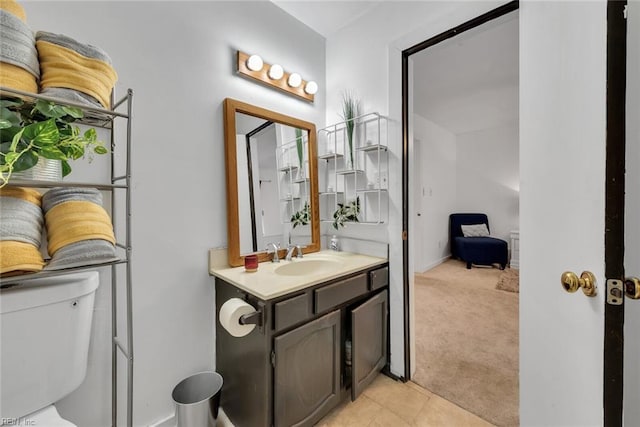 bathroom with vanity, toilet, and tile patterned floors