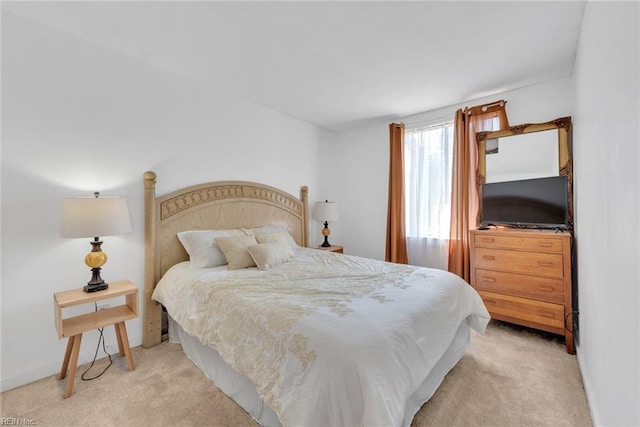 bedroom featuring light carpet