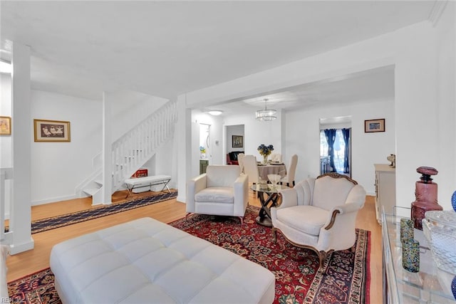 living room with a notable chandelier and wood-type flooring