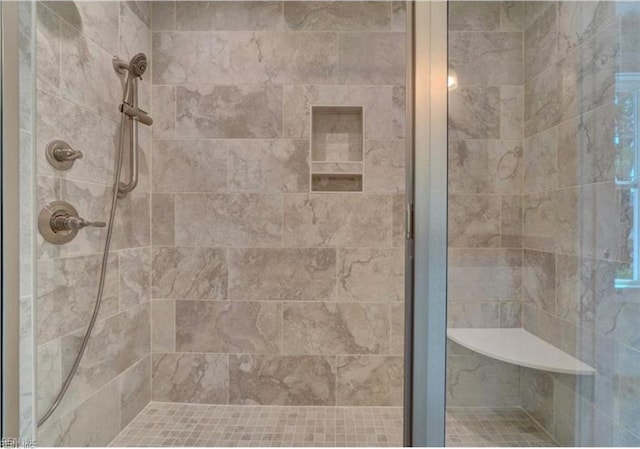 bathroom with a shower with shower door