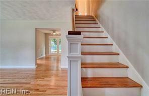 stairs featuring hardwood / wood-style floors