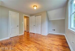 additional living space with light hardwood / wood-style floors