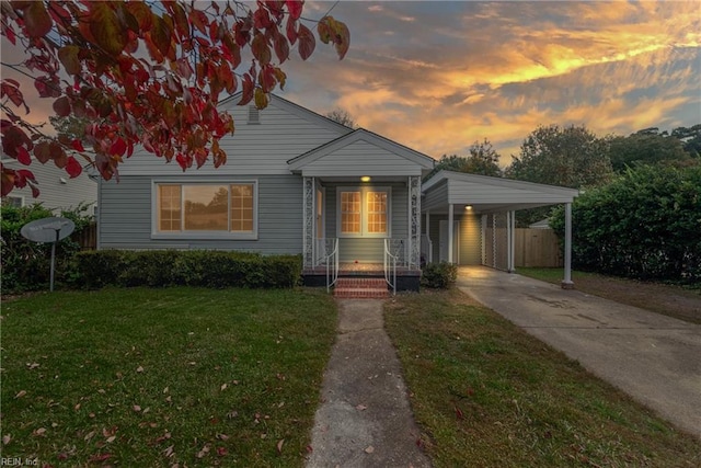 view of front of property featuring a lawn and a carport