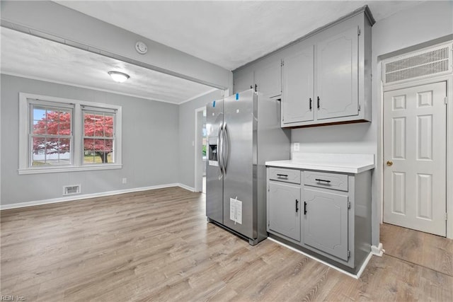 kitchen featuring stainless steel refrigerator with ice dispenser, gray cabinets, and light hardwood / wood-style floors