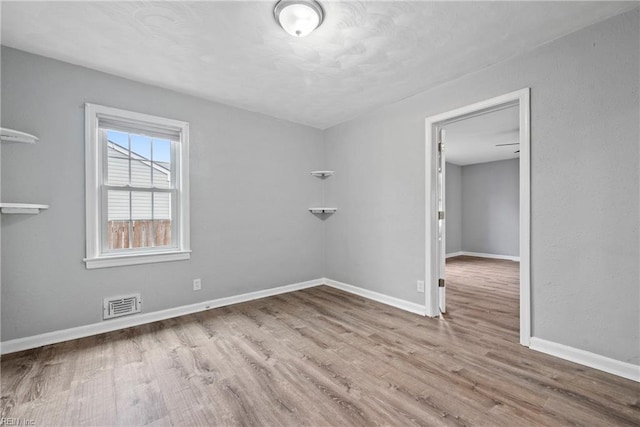 empty room featuring wood-type flooring