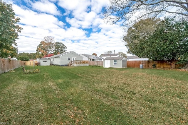 view of yard with a wooden deck and a storage shed