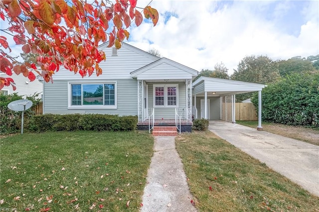 bungalow featuring a carport and a front yard