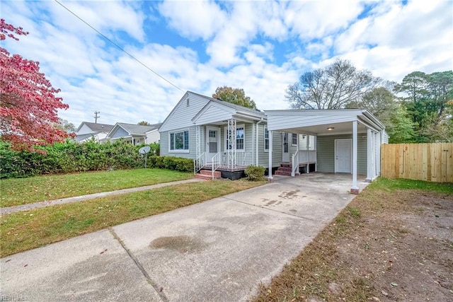 view of front of property with a front yard and a carport