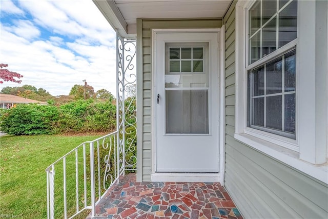 entrance to property featuring a yard