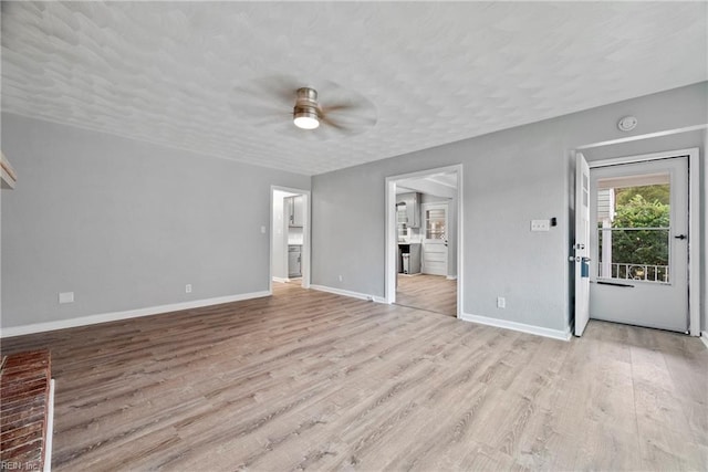 unfurnished living room featuring a textured ceiling, light hardwood / wood-style flooring, and ceiling fan