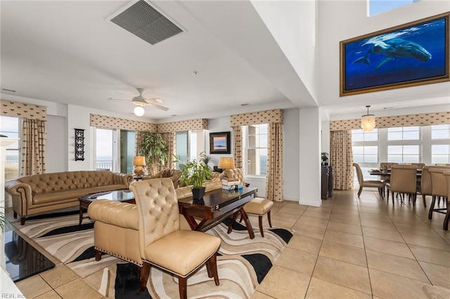 living room featuring light tile patterned floors, plenty of natural light, and ceiling fan