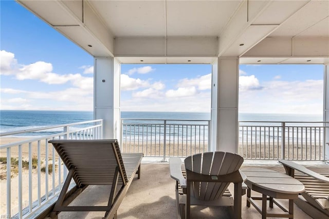 balcony featuring a water view and a view of the beach