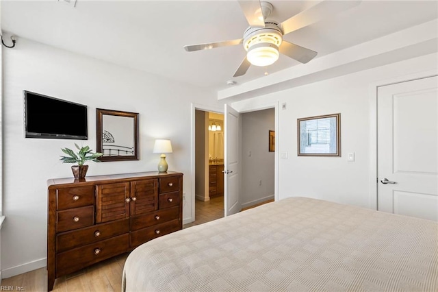 bedroom with light hardwood / wood-style floors, connected bathroom, and ceiling fan