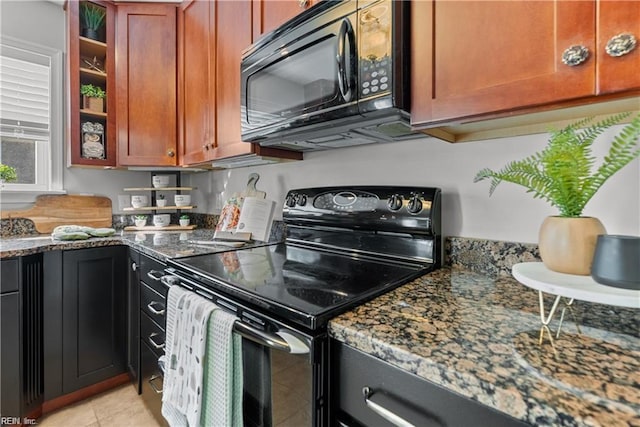 kitchen with black appliances, light tile patterned floors, and dark stone counters