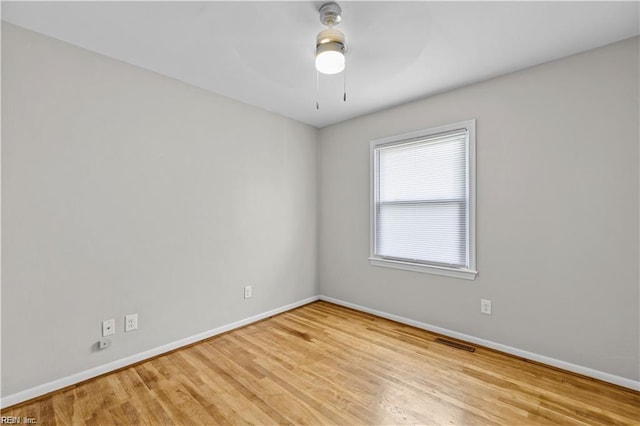 empty room with ceiling fan and light hardwood / wood-style floors