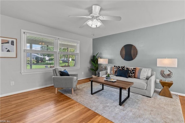 living room with ceiling fan and hardwood / wood-style flooring