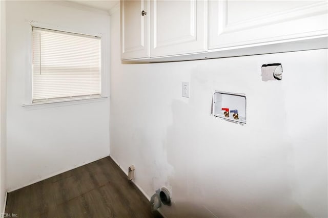 clothes washing area featuring cabinets, dark hardwood / wood-style floors, and washer hookup