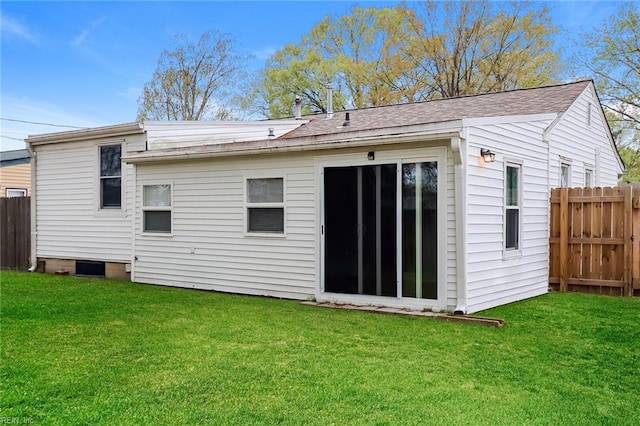 rear view of house with a yard