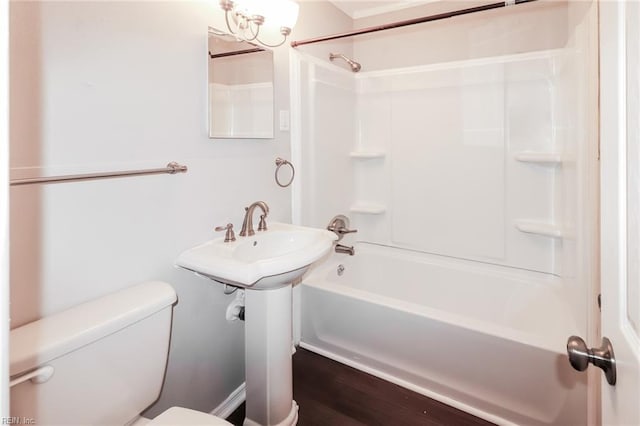 bathroom with toilet, shower / washtub combination, and hardwood / wood-style floors