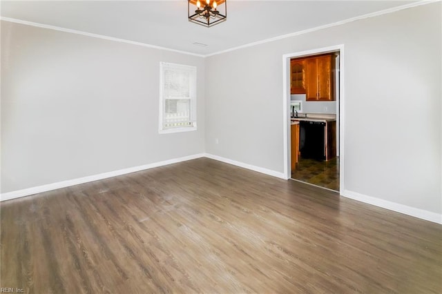 empty room with ornamental molding, dark wood-type flooring, and sink