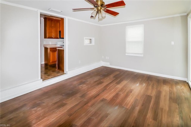 empty room featuring ornamental molding and dark hardwood / wood-style flooring