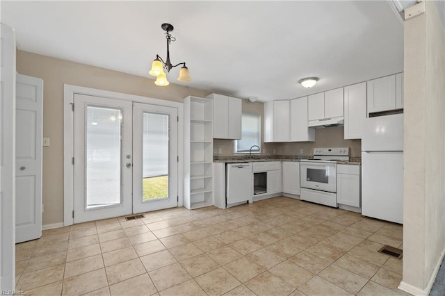 kitchen featuring a wealth of natural light, white cabinetry, decorative light fixtures, and white appliances