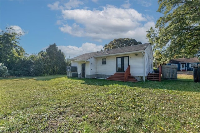 rear view of house with a yard