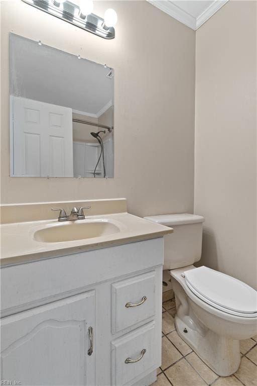 bathroom featuring toilet, crown molding, vanity, and tile patterned floors