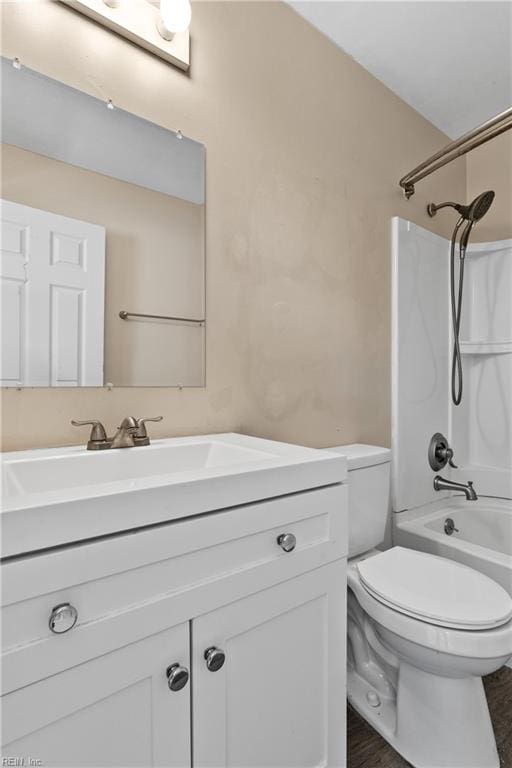 full bathroom featuring vanity, toilet, and  shower combination